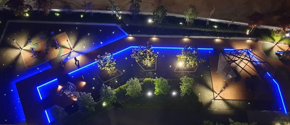 Lit planters and pathways at night at Cerrado